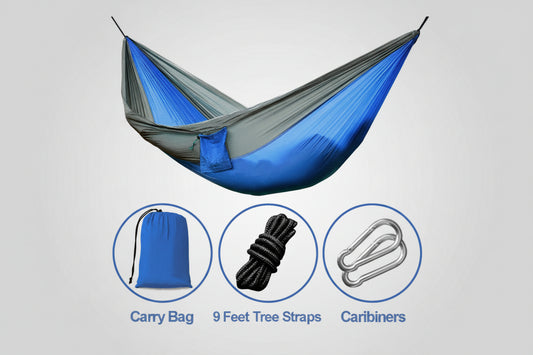 Blue and gray hammock with accessories including a carry bag, tree straps, and carabiners on a white background.