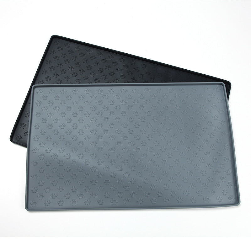 Two black pet mats with paw print pattern on a white background