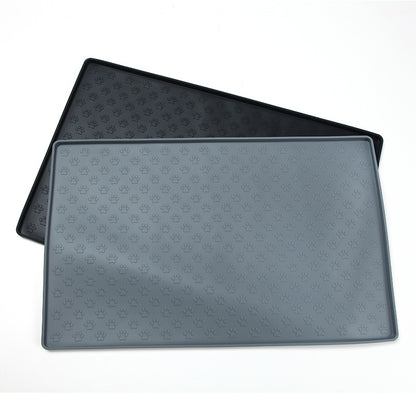 Two black pet mats with paw print pattern on a white background