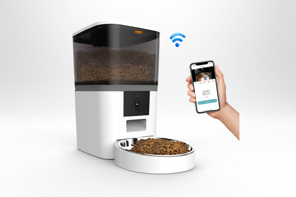 Smart pet feeder with a bowl of food and a hand holding a smartphone with an app interface.
